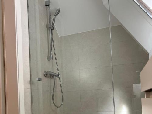 a bathroom with a shower with a glass door at Studio near to the City Centre in Luxembourg