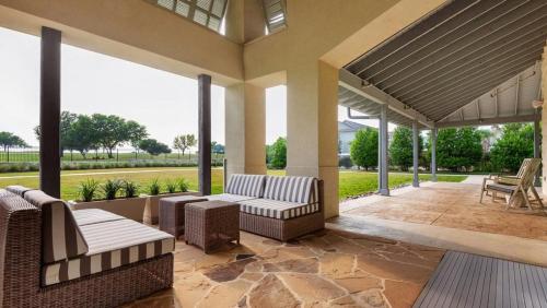 a porch with couches and chairs on a patio at Landing at The Green at Plum Creek - 1 Bedroom in Kyle in Kyle