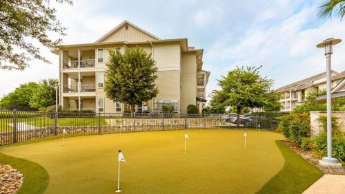 a golf course in front of a building at Landing at The Green at Plum Creek - 1 Bedroom in Kyle in Kyle