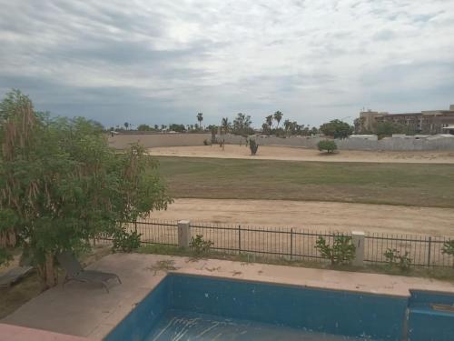 a view of a field with elephants in the distance at Casona in San José del Cabo