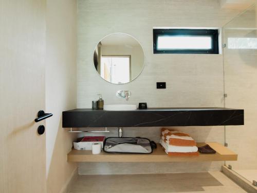 a bathroom with a sink and a mirror at The Village K´AAX in Tulum