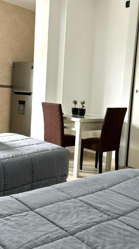 a room with a table and two chairs and a table and a table at Studio San in Santiago del Estero