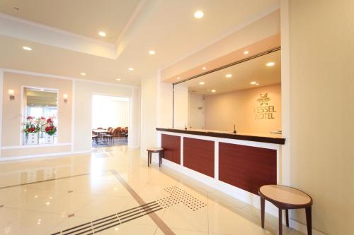 a lobby with a bar and a dining room at Vessel Hotel Miyakonojo in Miyakonozyō