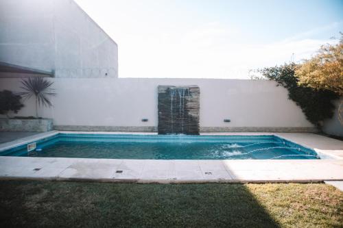 a swimming pool in the backyard of a house at Catriel Suites in Catriel