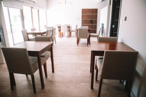 a dining room with wooden tables and chairs at Catriel Suites in Catriel