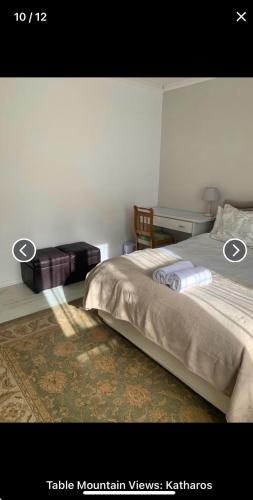 a bedroom with a bed and a desk at Table Mountain Views in Cape Town