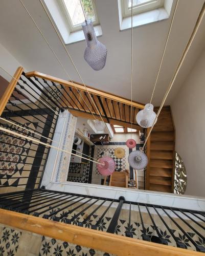 a spiral staircase in a house with two lights at כוהנ'ס Cohen's Boutique Hotel in Haifa