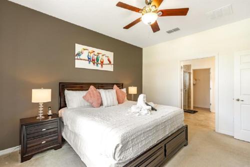 a bedroom with a bed and a ceiling fan at 494 - Fabulous 5 Bed Villa with South West Facing pool and Spa Overlooking Water and Conservation in Loughman