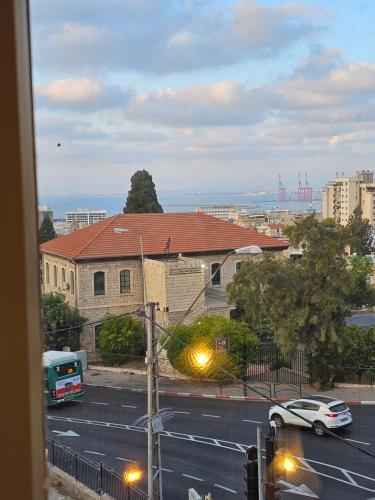 a view from a window of a street with a car at כוהנ'ס Cohen's Boutique Hotel in Haifa