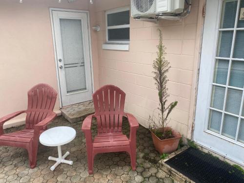 two chairs and a table in front of a house at Botanical Tranquility in Orlando