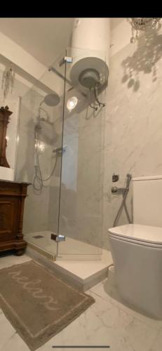 a bathroom with a glass shower with a toilet at appartamenti con terrazo solare in Perugia