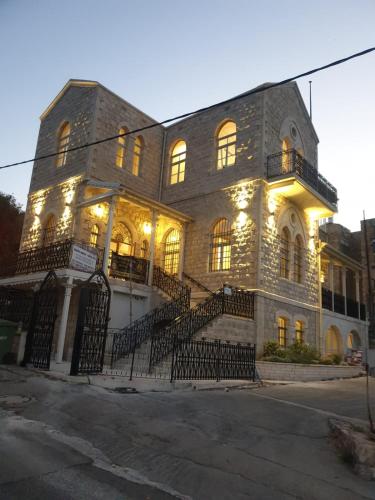 a large stone building with lights on it at כוהנ'ס Cohen's Boutique Hotel in Haifa