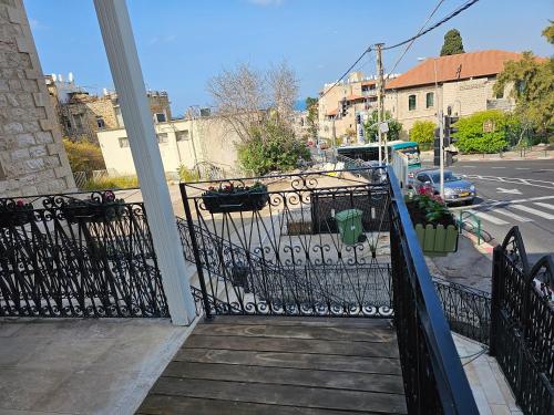 a balcony with a black gate and a street at כוהנ'ס Cohen's Boutique Hotel in Haifa