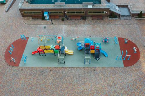 an overhead view of a playground with play equipment at Odesa Pearl Apartments in Odesa