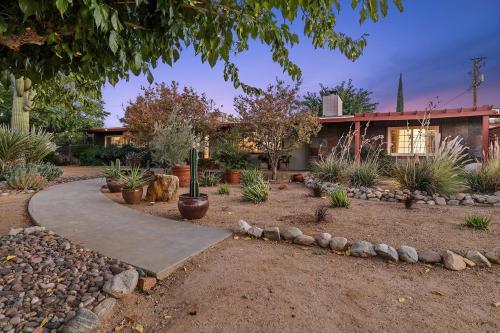 a garden with a walkway in front of a house at Ember Stone in Yucca Valley