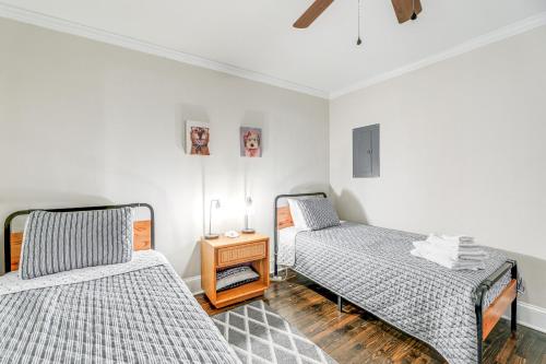a bedroom with two beds and a night stand at New Bern Retreat with Fire Pit about 1 Mi to Dtwn! in New Bern