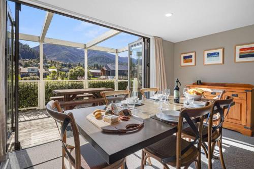 a dining room with a table and chairs at *** LAKE VILLA 457 *** in Hanmer Springs