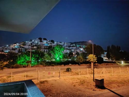 a view of a city at night with green lights at SUNSET AİRPORT VİLLA in Dalaman