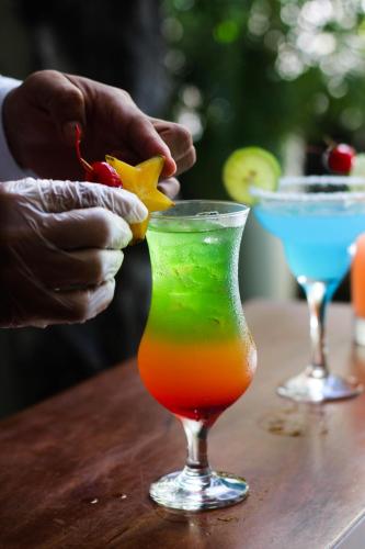 a person is putting a star in a drink at El Dorado Classic Hotel in Iquitos