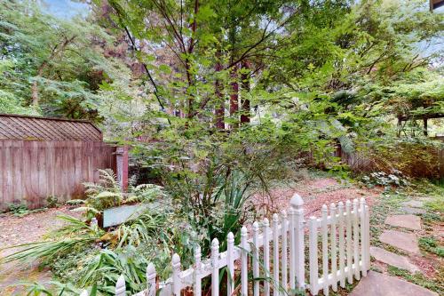 a white picket fence in front of a tree at Summerhouse in Monte Rio