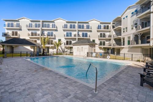 a swimming pool in front of a apartment building at Pelican Crossing by Pristine Properties Vacation Rentals in Cape San Blas