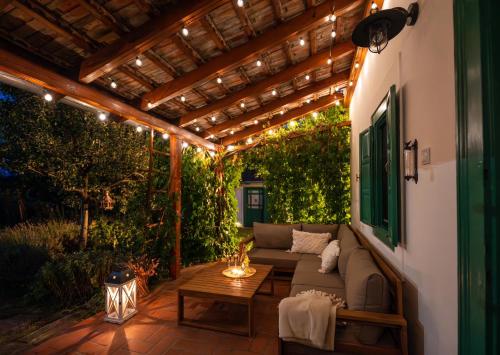 an outdoor patio with a couch and a table at Carpe diem Vendégház in Cserépfalu