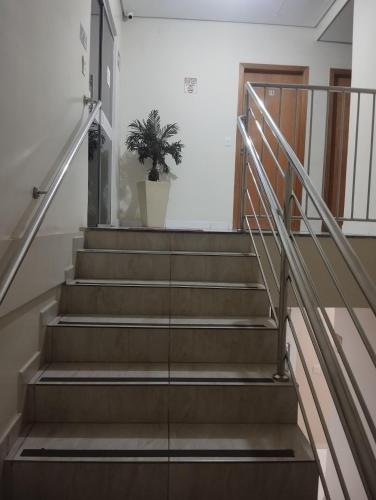 a staircase in a house with a potted plant at Líder Hotel in Goiânia