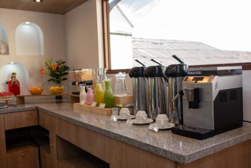 a kitchen counter with a coffee maker on it at Hotel San Pedro Plaza in Cusco