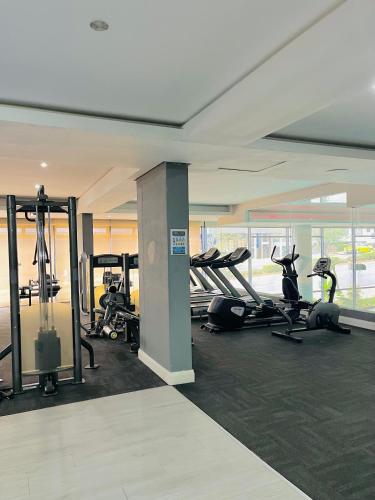 a gym with treadmills and exercise equipment in a building at Urban Park K001, Umhlanga Rocks in Durban