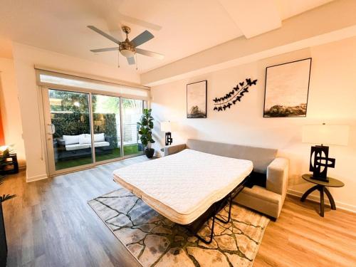 a bedroom with a bed and a ceiling fan at Luxury Open BD w Pool, Parking, & WD 133 in Los Angeles