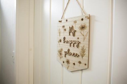 a sign that says happy birthday hanging on a wall at Central Studio Apartments in Stratford upon Avon in Shottery