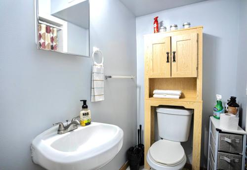 a bathroom with a white toilet and a sink at Lovely Loft in Newark Minutes from NYC, EWR & American Dream Mall in Newark