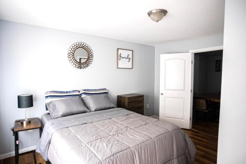 a bedroom with a bed and a mirror on the wall at Lovely Loft in Newark Minutes from NYC, EWR & American Dream Mall in Newark