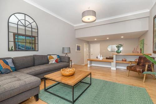 a living room with a couch and a table at Bright and Central Duplex in Glasgow City Centre in Glasgow
