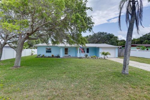a blue house with trees in a yard at Pet-Friendly Cocoa Beach Home Walk to Beach! in Cocoa Beach