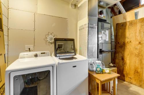 a room with a washing machine and a tv at Pet-Friendly Cocoa Beach Home Walk to Beach! in Cocoa Beach