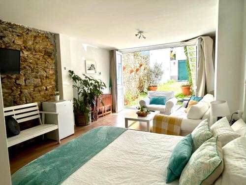 a bedroom with a bed and a living room at El Galeón in Ribadeo