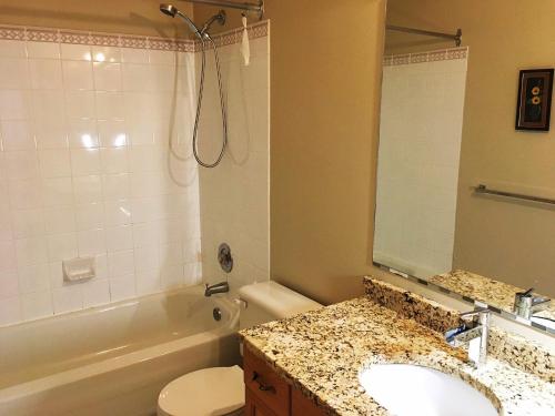 a bathroom with a sink and a tub and a toilet at Bedrooms in Kenaston, Close to Walmart, Costco, IKEA, Outlet in Winnipeg
