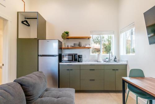 a kitchen with a stainless steel refrigerator and a table at Casitas at Capitol Reef in Torrey