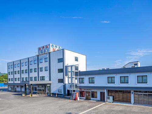 a white building with a tower on top of it at Hotel Nami in Kumano
