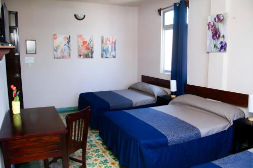 Postel nebo postele na pokoji v ubytování Hotel Cortaza Galería