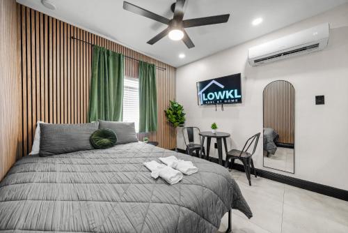 a bedroom with a bed and a table with chairs at Baybreeze Apartments by Lowkl in Miami Beach
