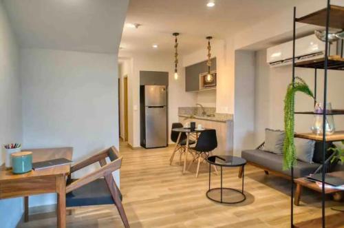 a living room with a couch and a table at Estudio remodelado en Marina Vallarta in Puerto Vallarta
