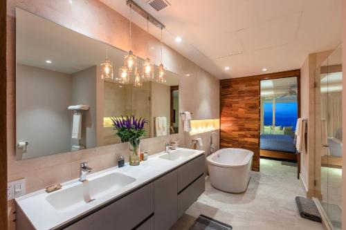 a bathroom with two sinks and a toilet and a mirror at 4 BR Casa Indah is a Gorgeous New 3400 SF Condo in Puerto Vallarta