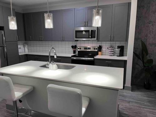 a kitchen with a sink and a stove top oven at Central Buckhead Suite in Atlanta