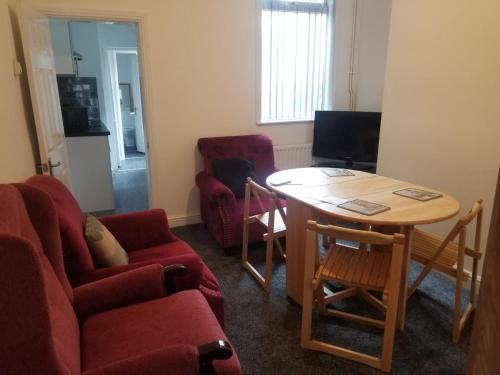 a living room with a couch and a table and chairs at Cosy Home Stay in Etruria