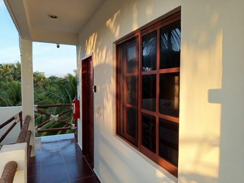 a balcony with a window and a view of the ocean at Casa aloha-Isla Holbox in Holbox Island