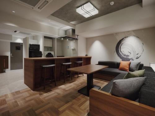 a living room with a couch and a table at MONday Apart Premium Asakusa in Tokyo