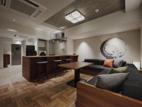 a living room with a couch and a table at MONday Apart Premium Asakusa in Tokyo
