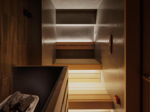 a walk in closet with wooden shelves and a refrigerator at MONday Apart Premium Asakusa in Tokyo